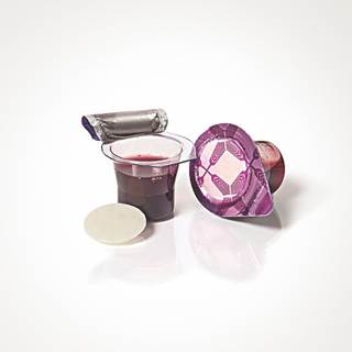 A prepackaged communion cup with grape juice and a wafer