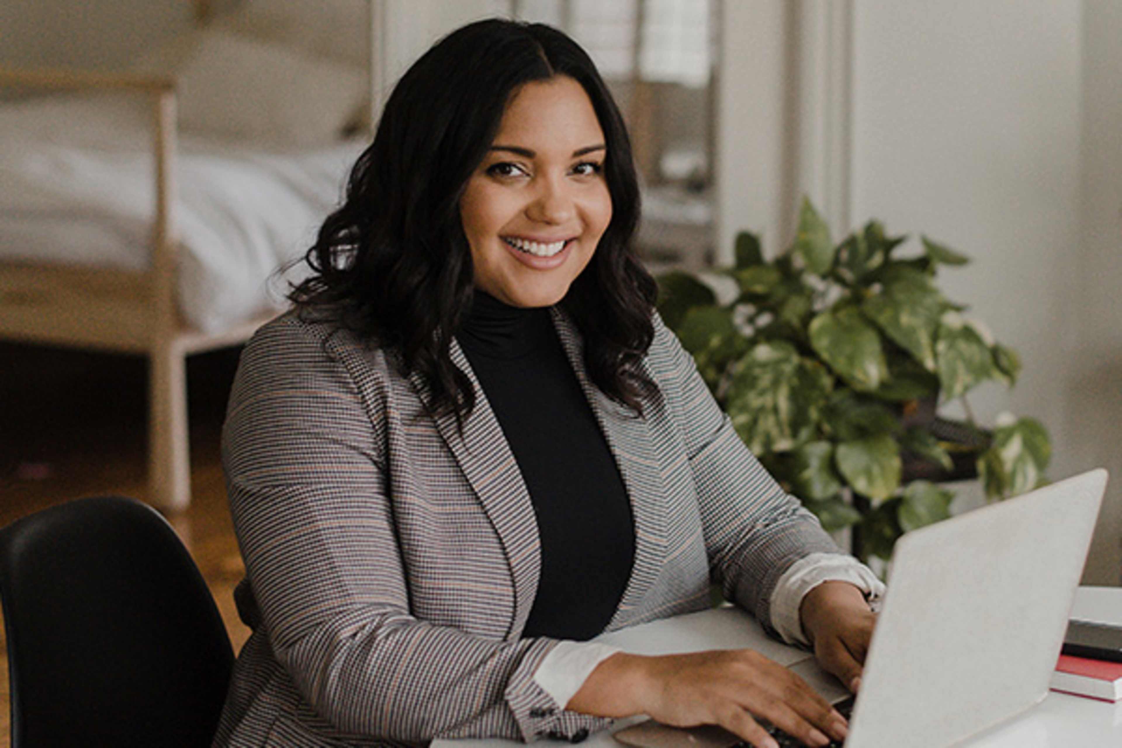 Young woman smiling as she works on a computer