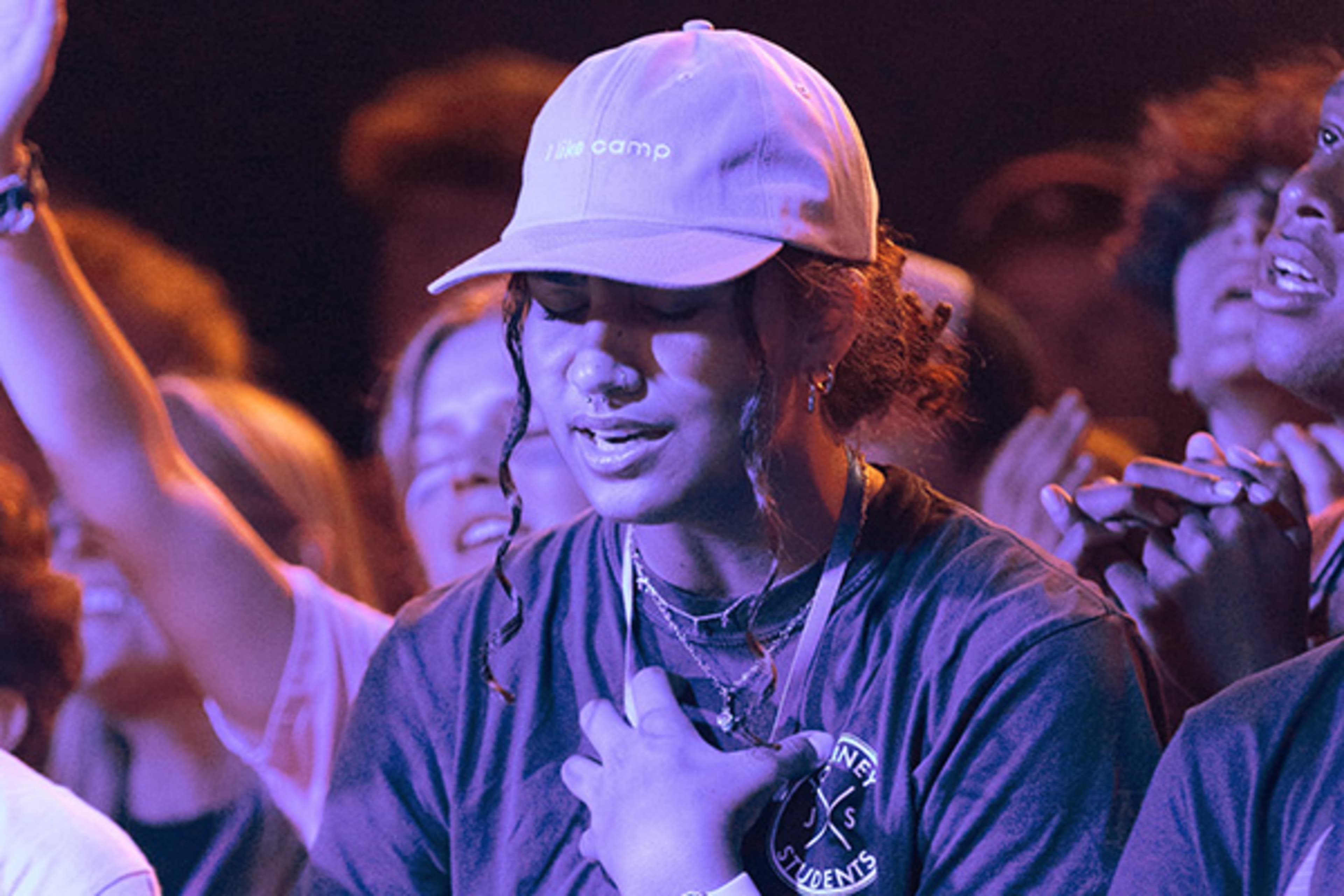 Girl student at worship in a crowd