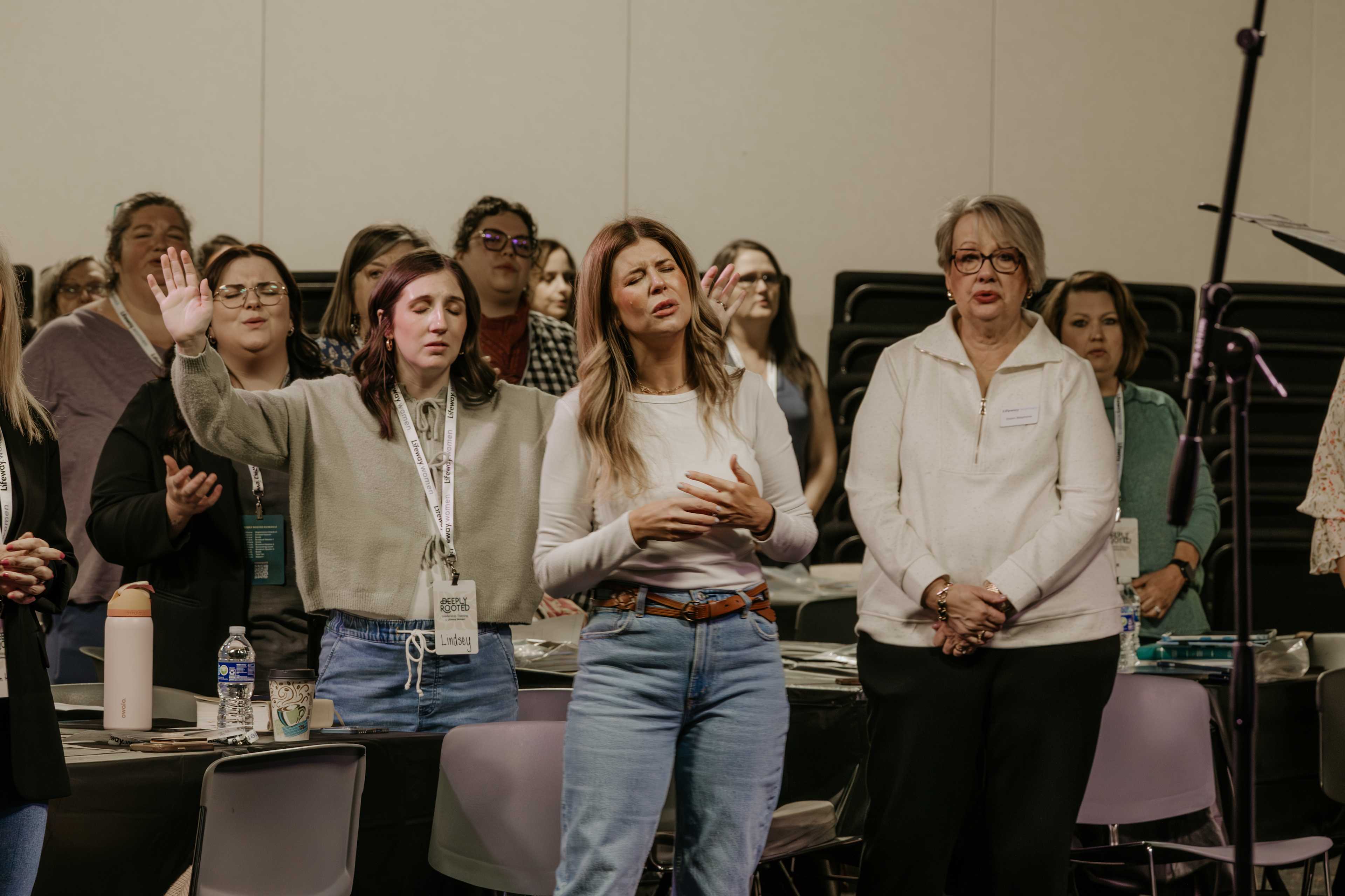 Women standing around table singing