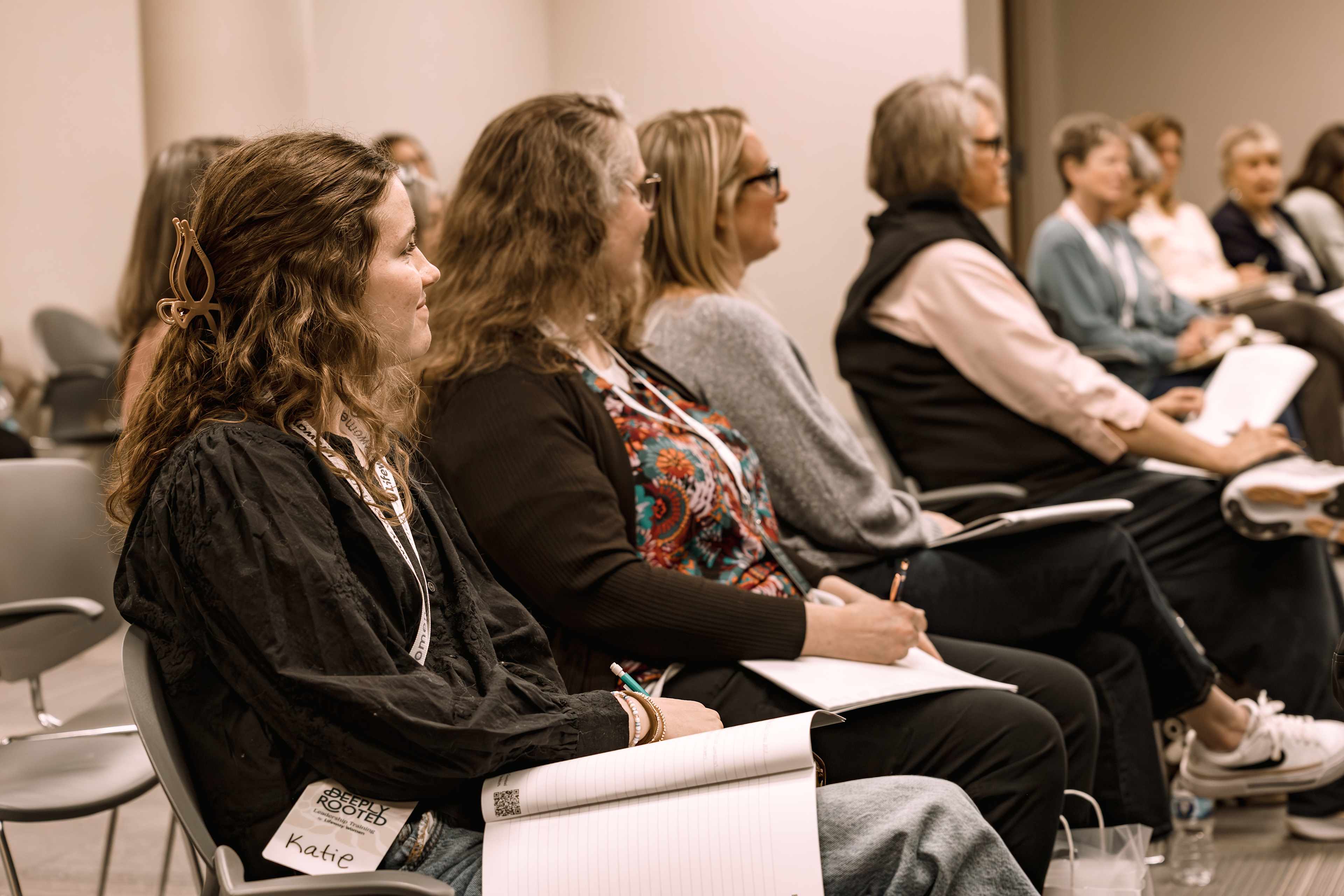 Women sitting in chairs looking to their left