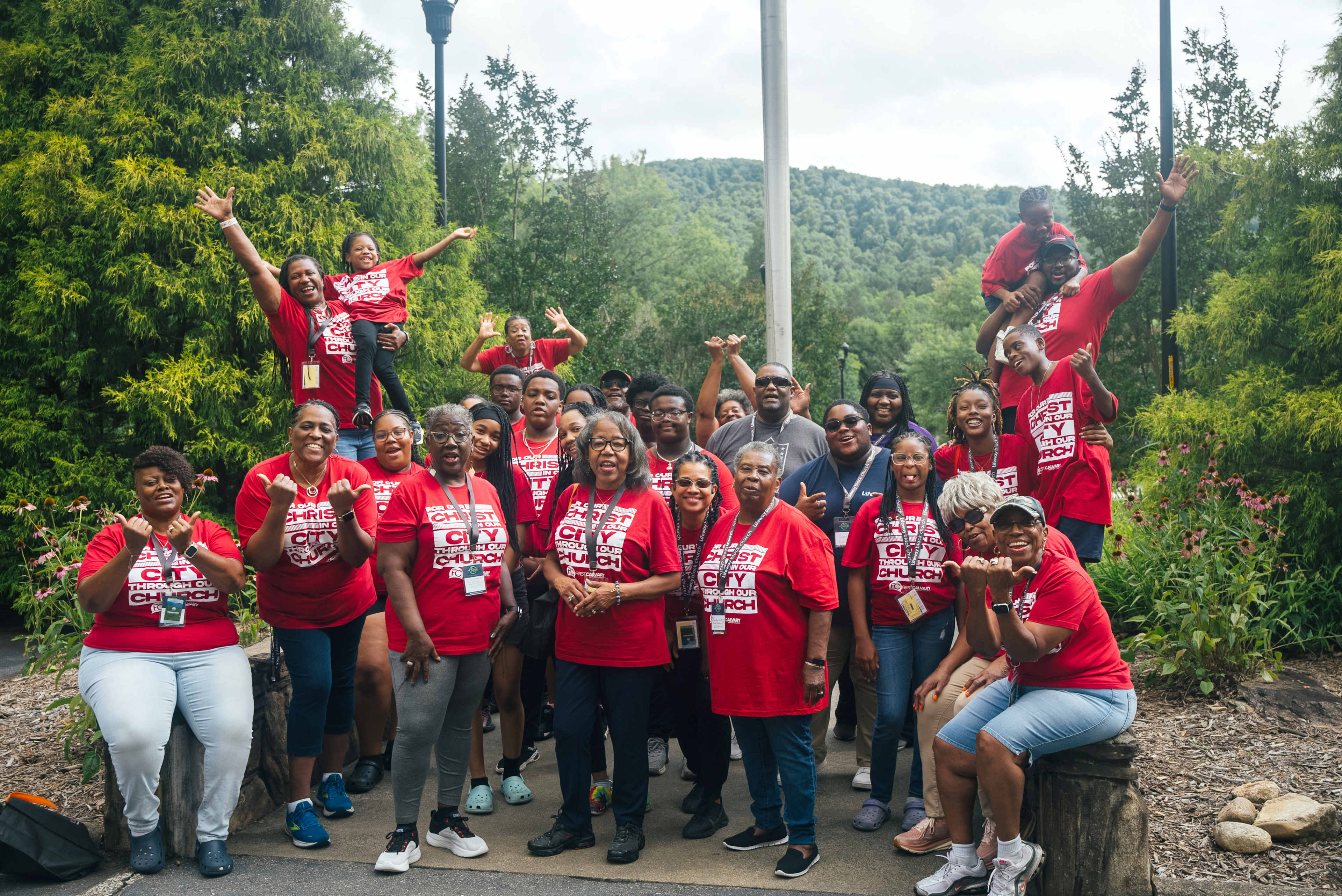 Group photo of a large group of children and teens wearing yellow shirts