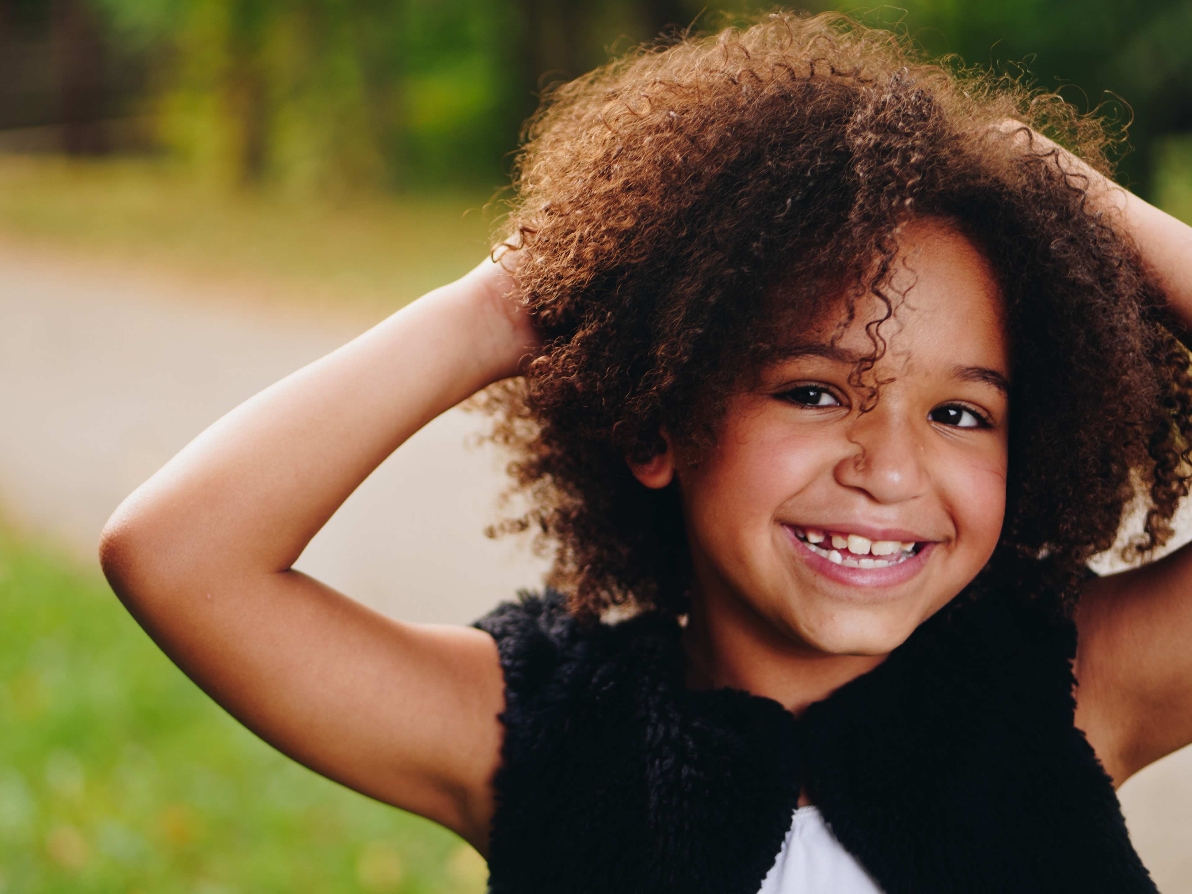 African-American girl with hands in hair