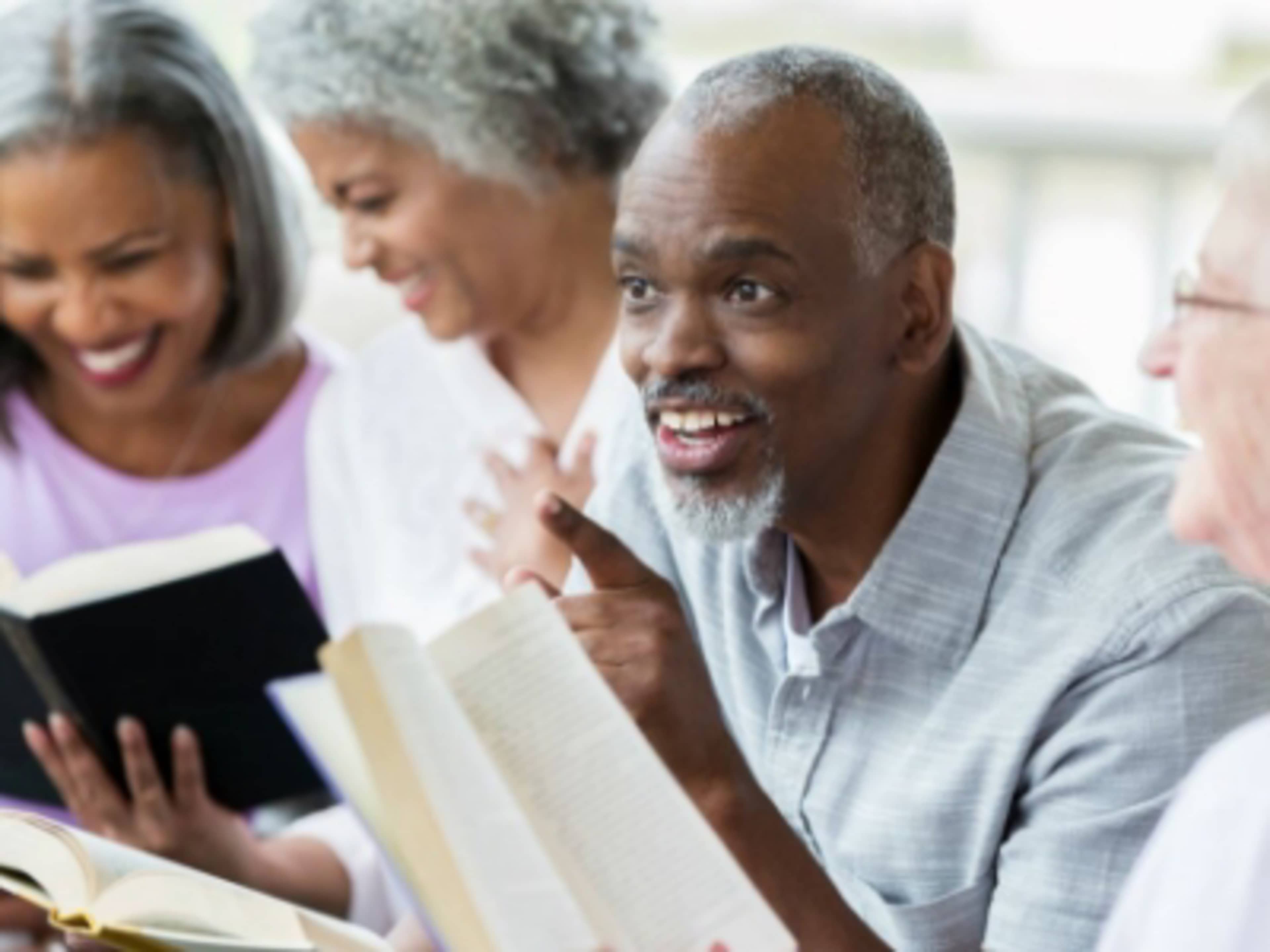 senior adults sitting in a circle reading Bible