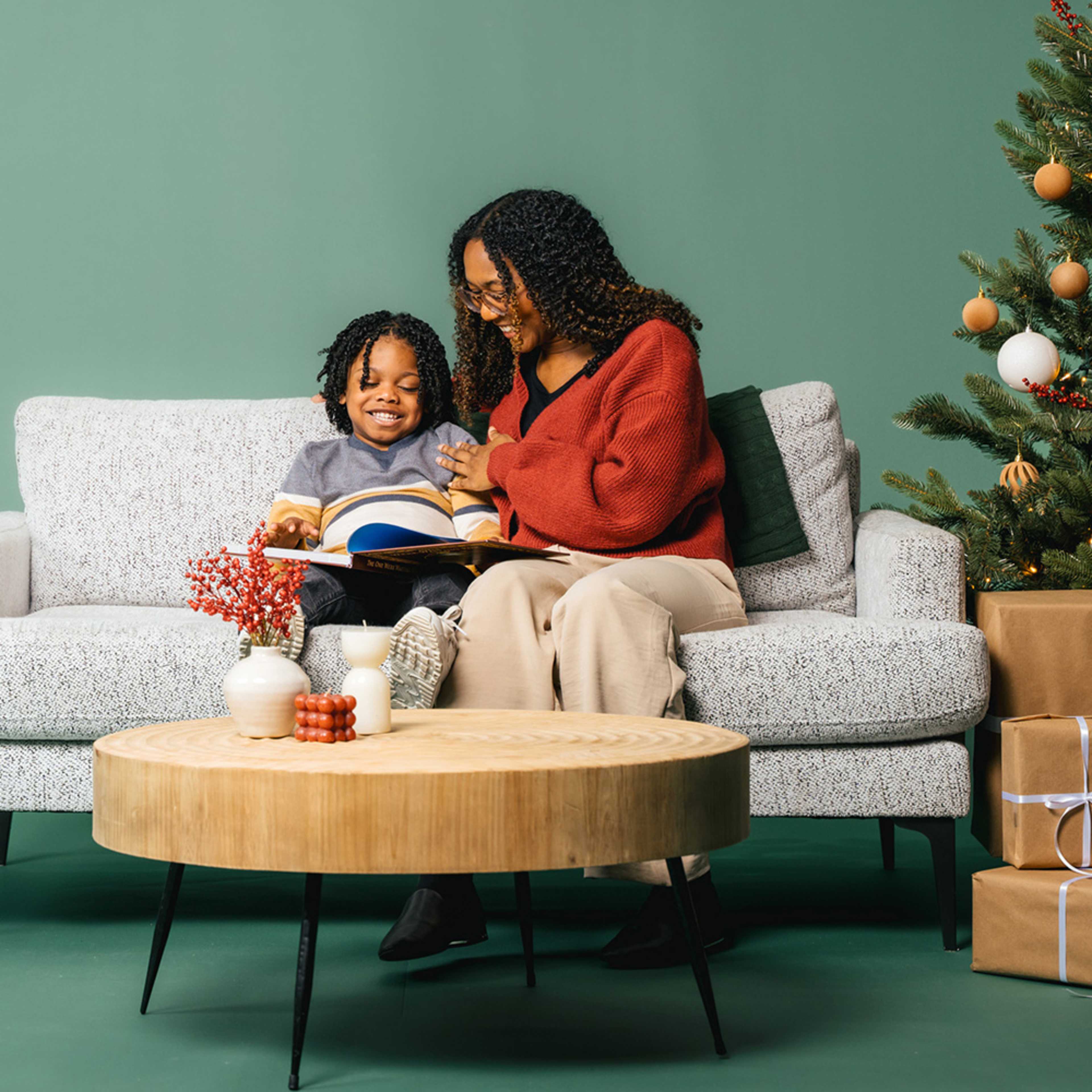 mother and son reading the Bible on a couch