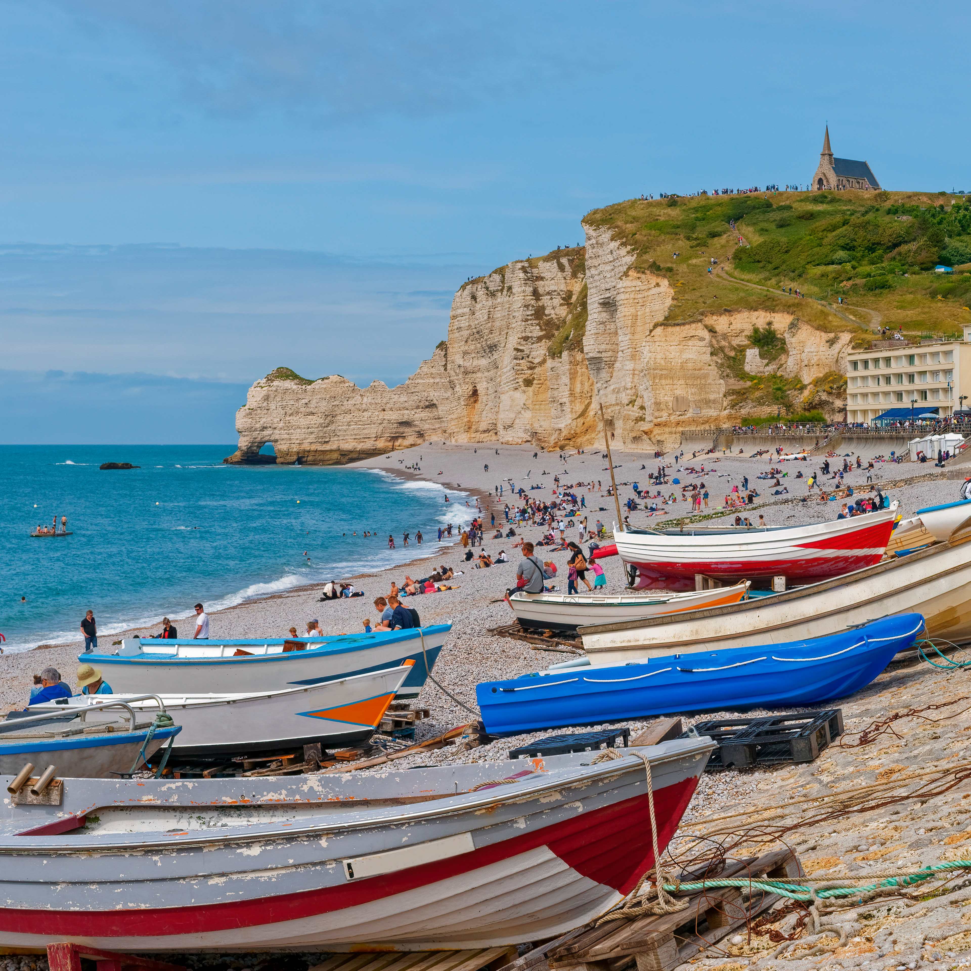 Beach with people and boats on shore