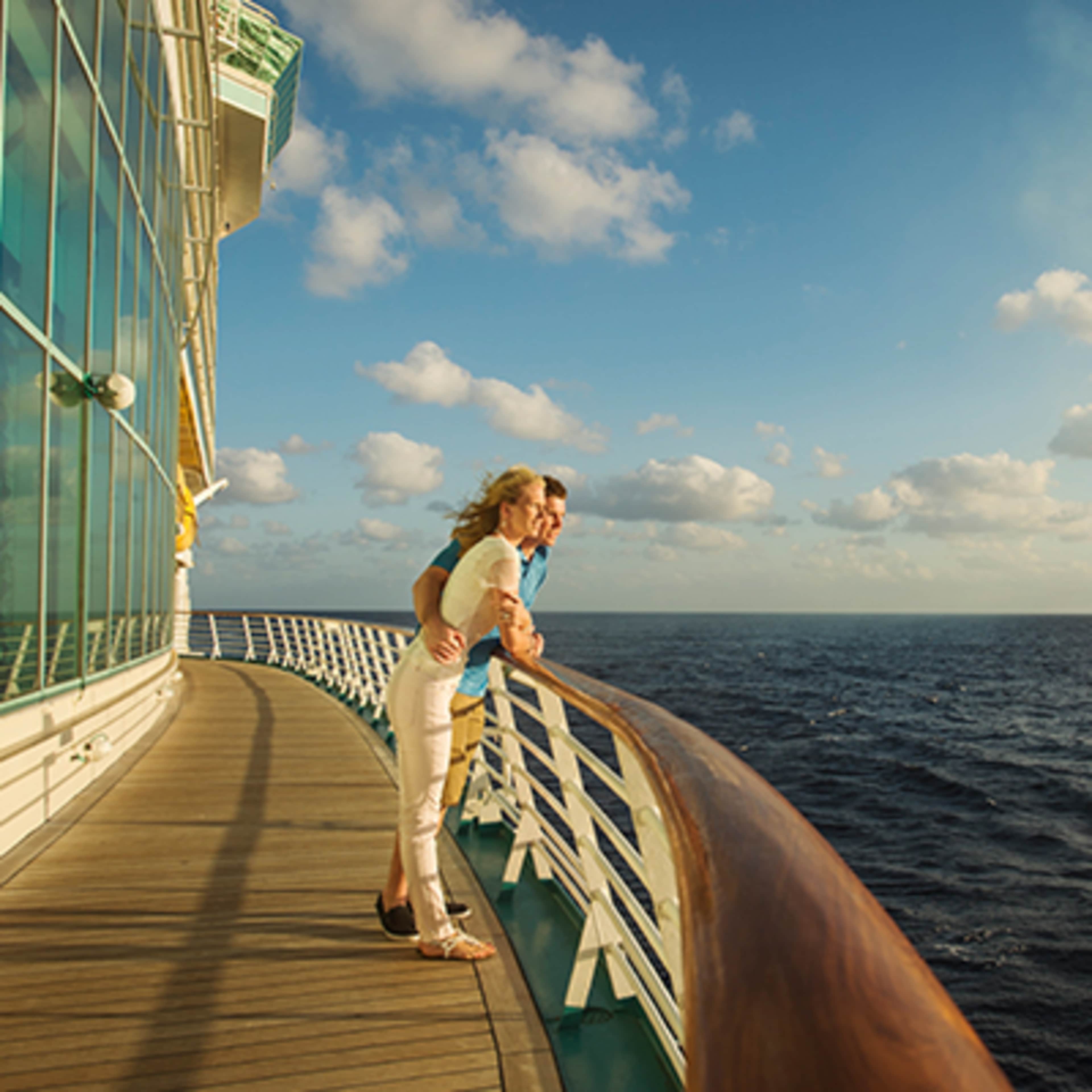 Couple on railing of cruise ship
