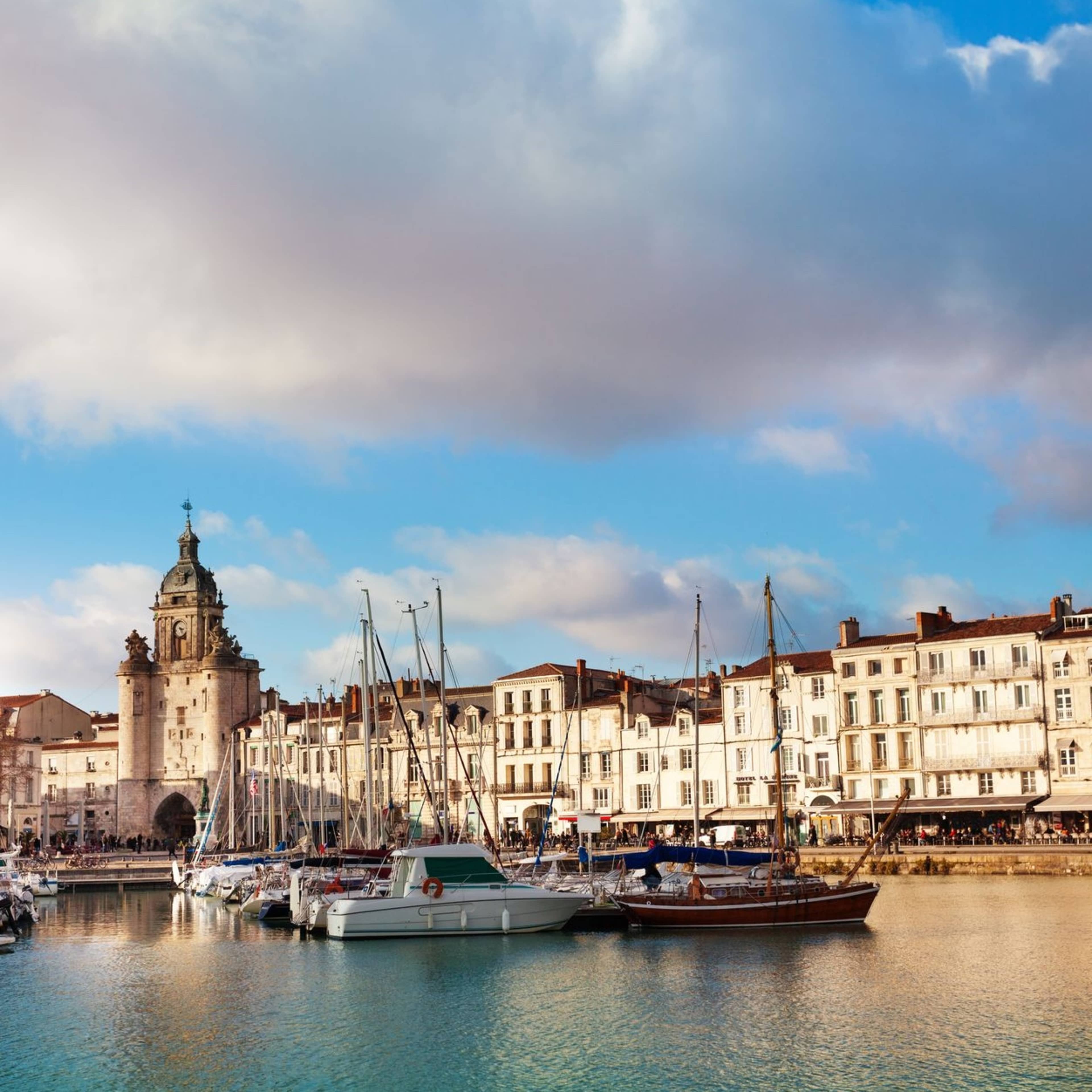 sailboats in a bay with buildings in background