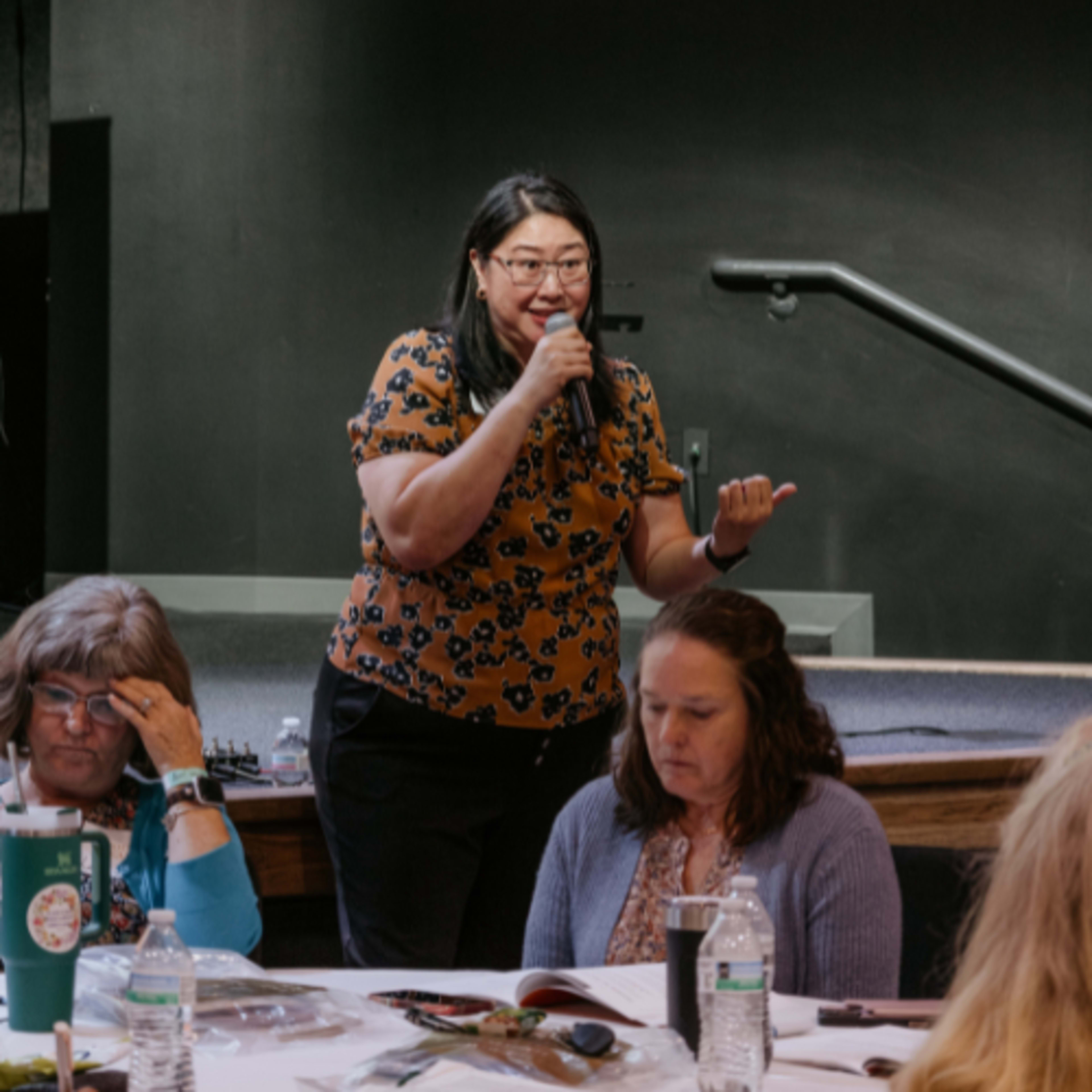 Asian woman speaking to a crowd