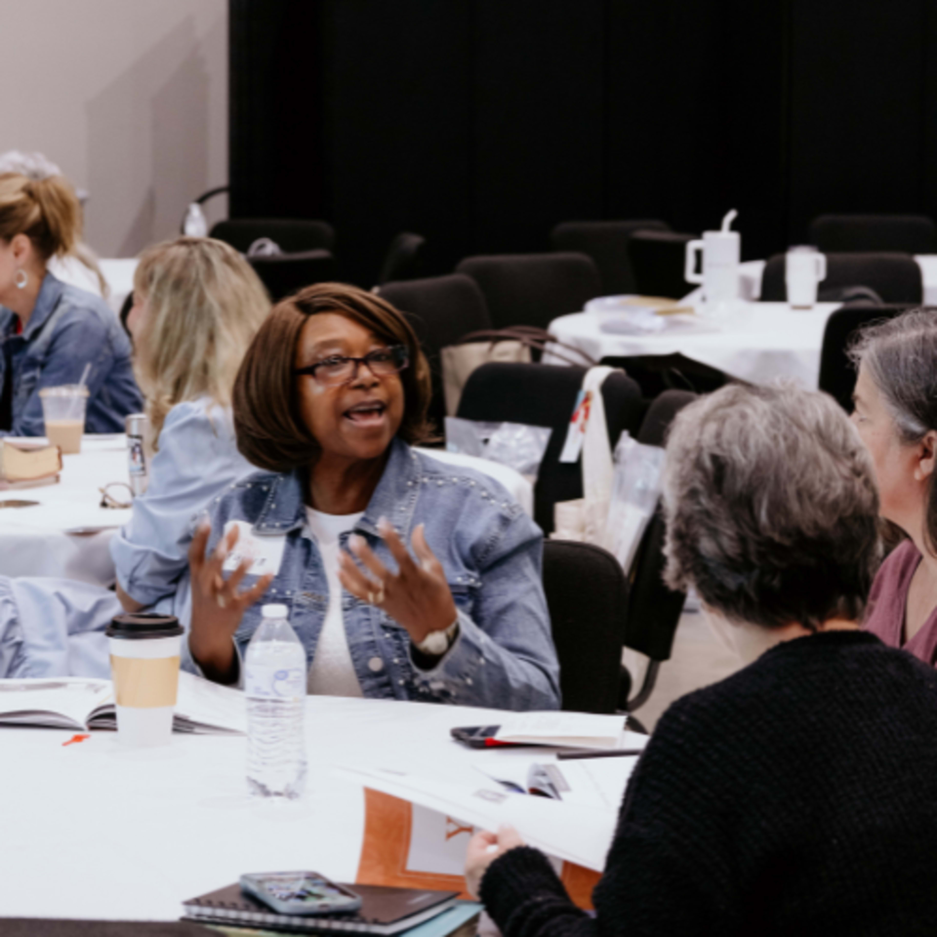 African-American woman speaking at a table
