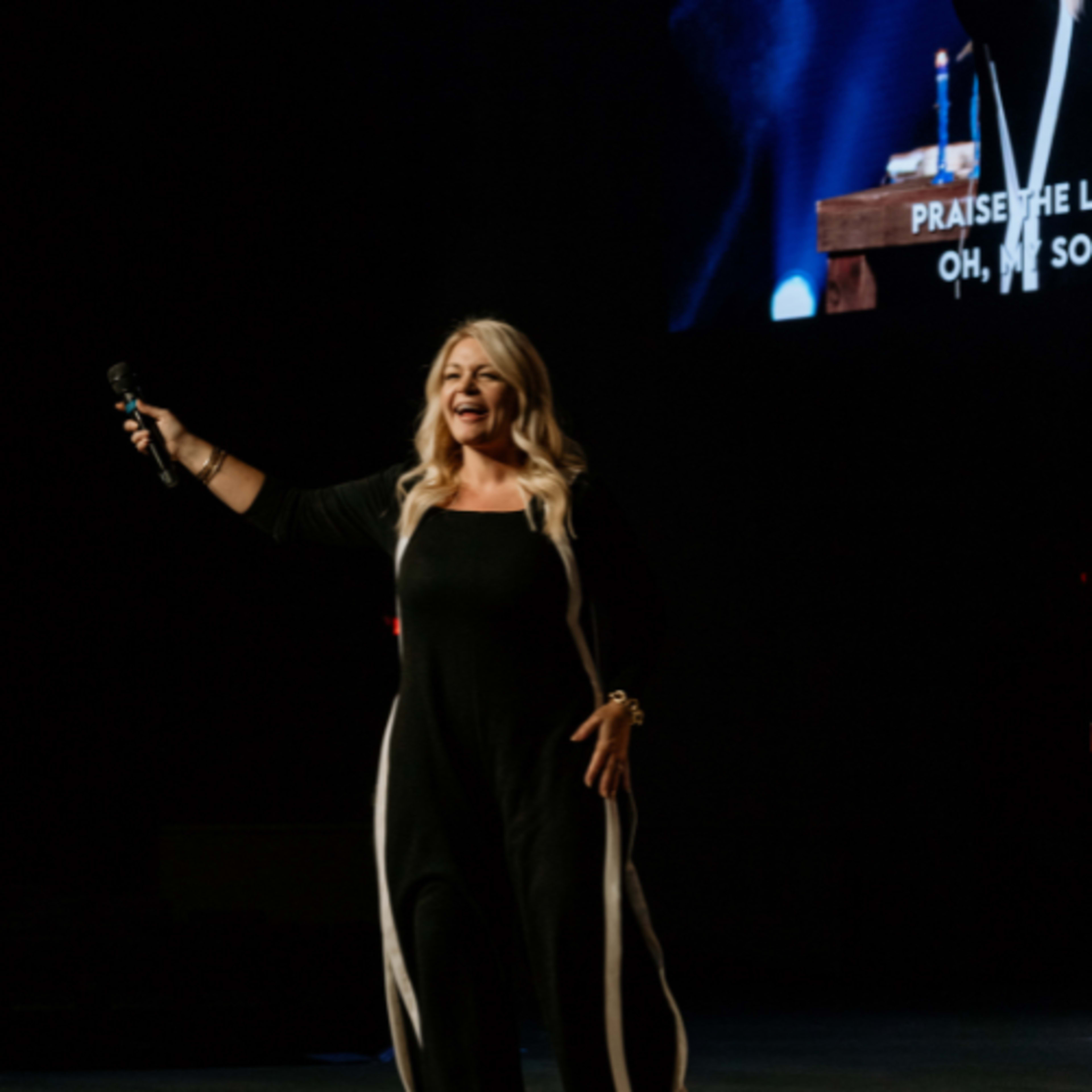 woman in black dress singning