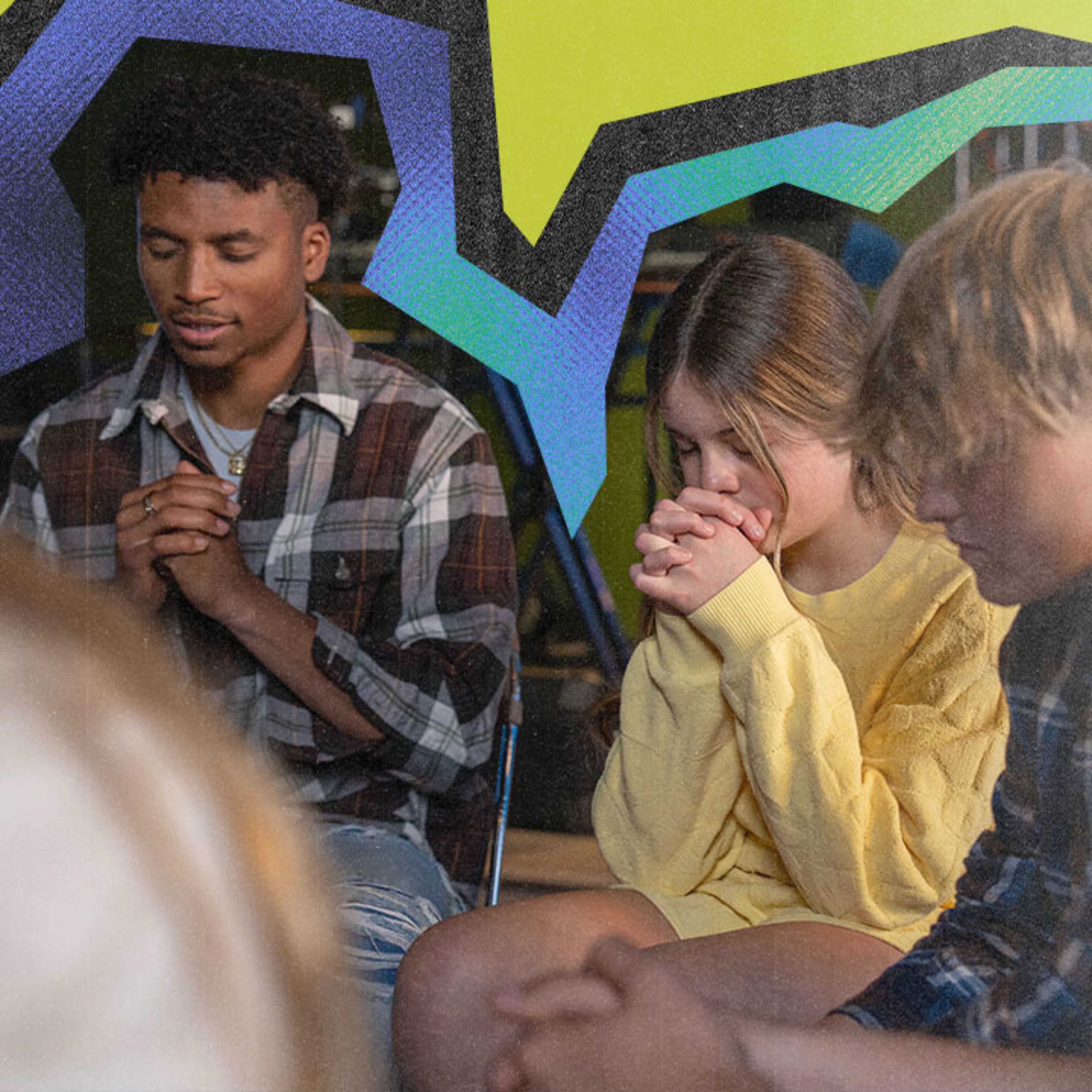 Teenagers praying with folded hands