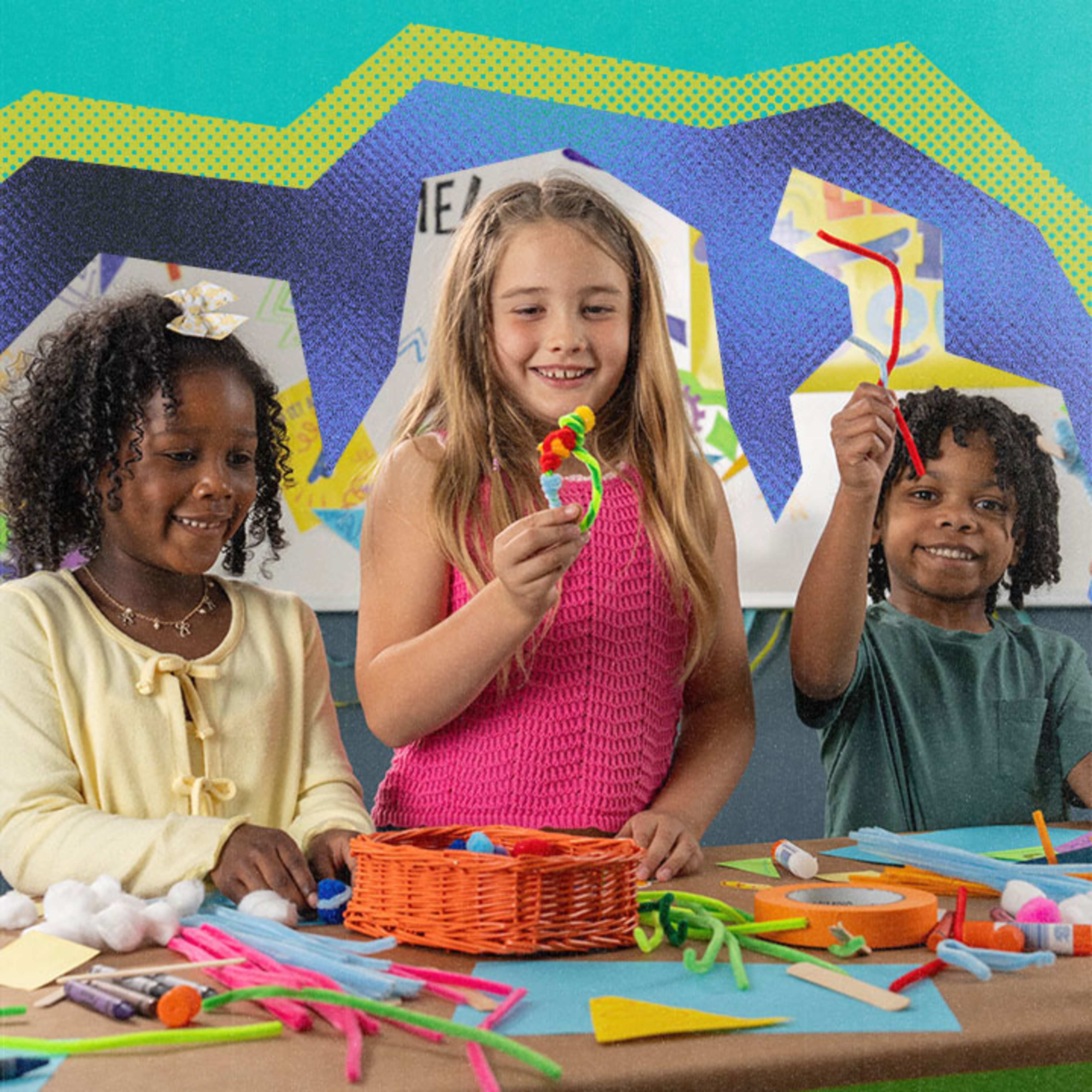 Three kids holding crafts and smiling