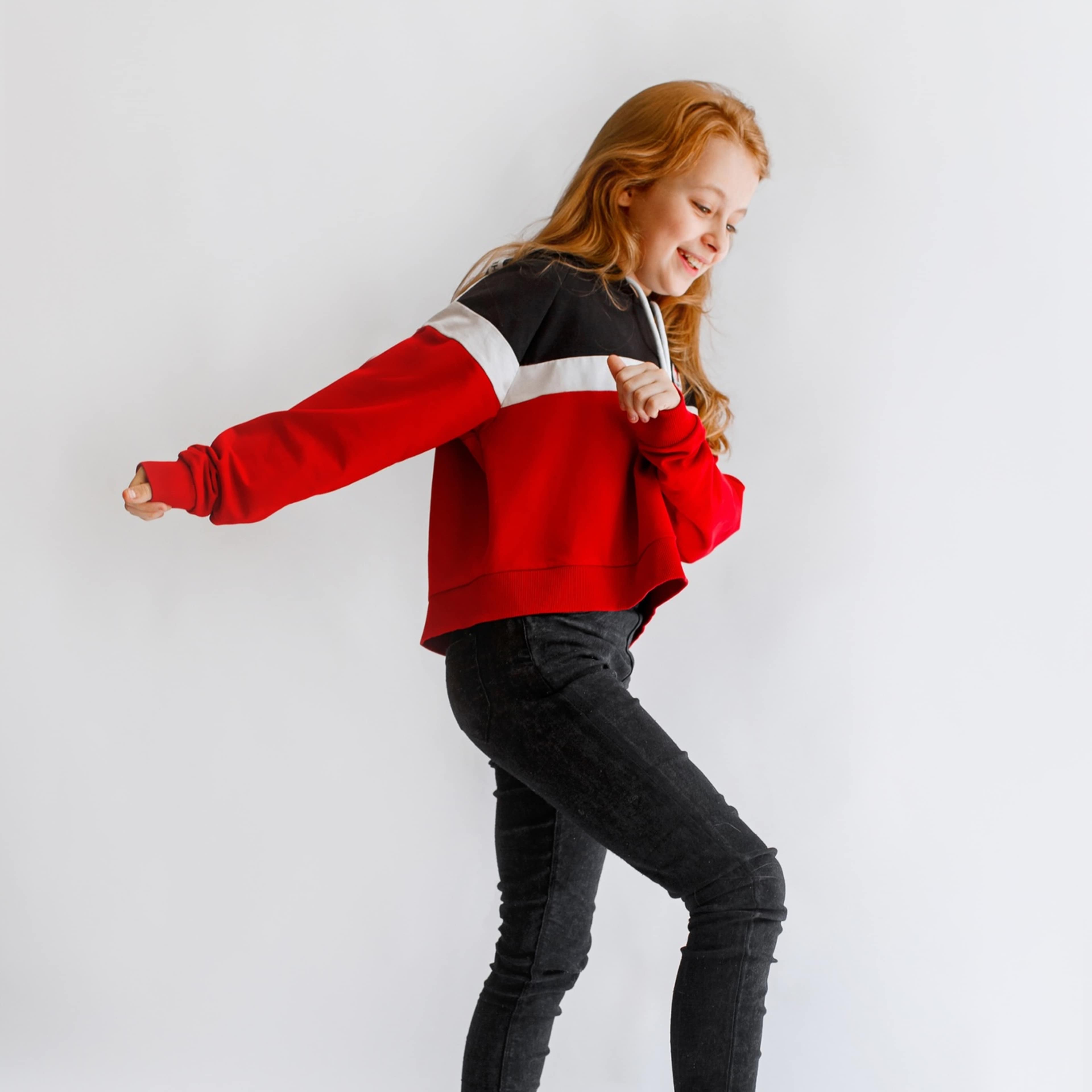 girl in red sweater looking to her left