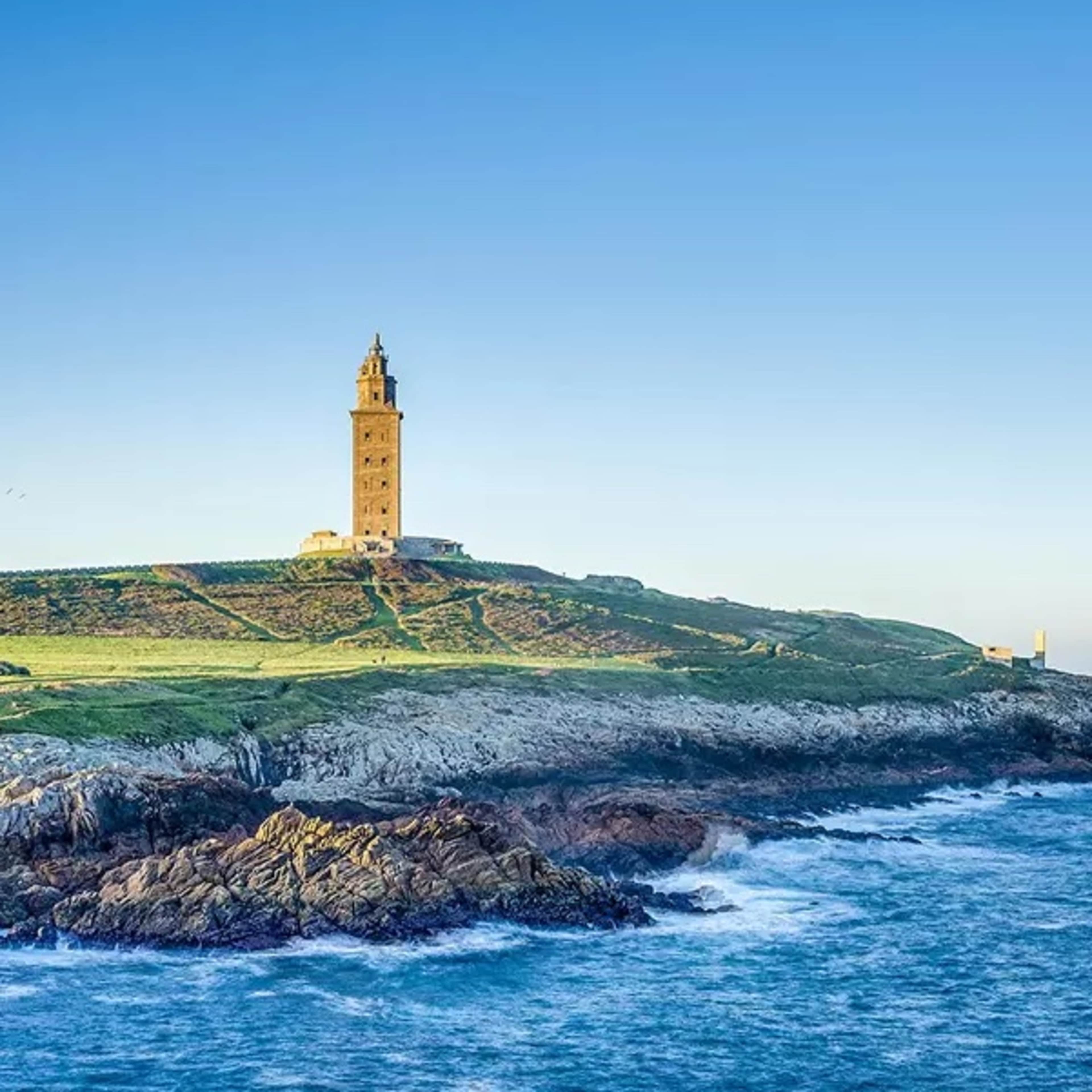 Ocean shore with lighthouse on a hill