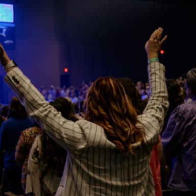 girl worshipping with raised arms