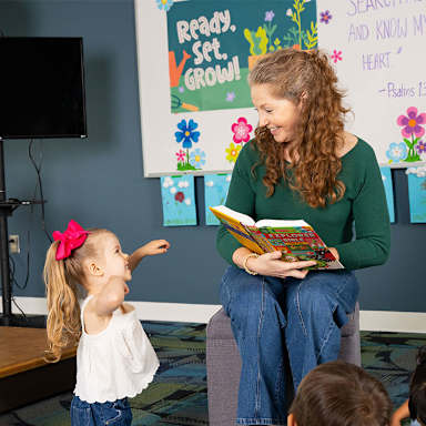 Woman reading book to toddler