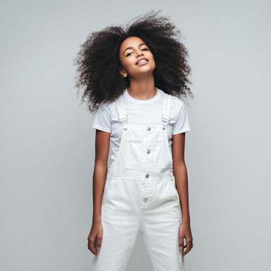 Girl in white overalls