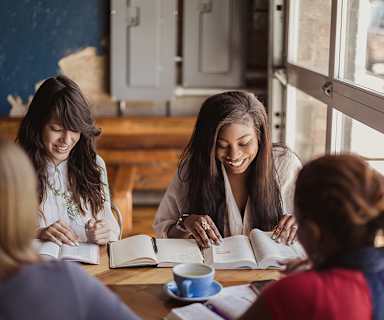 women at a coffee shop studying the Bible