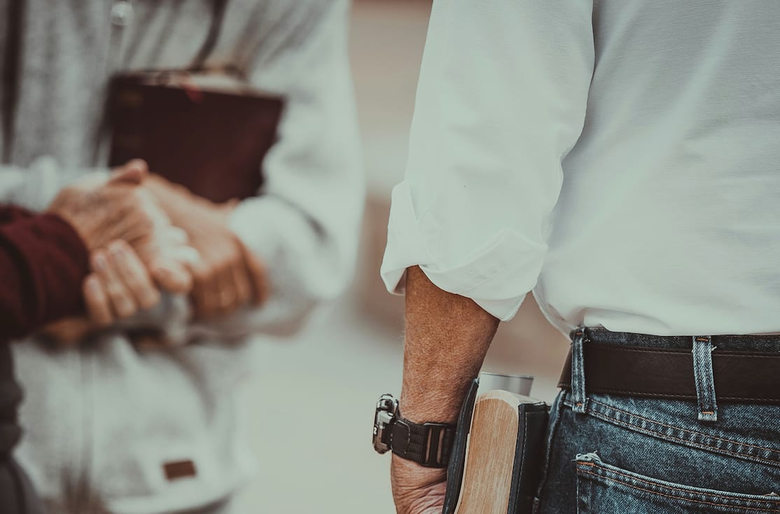 men talking holding their Bible