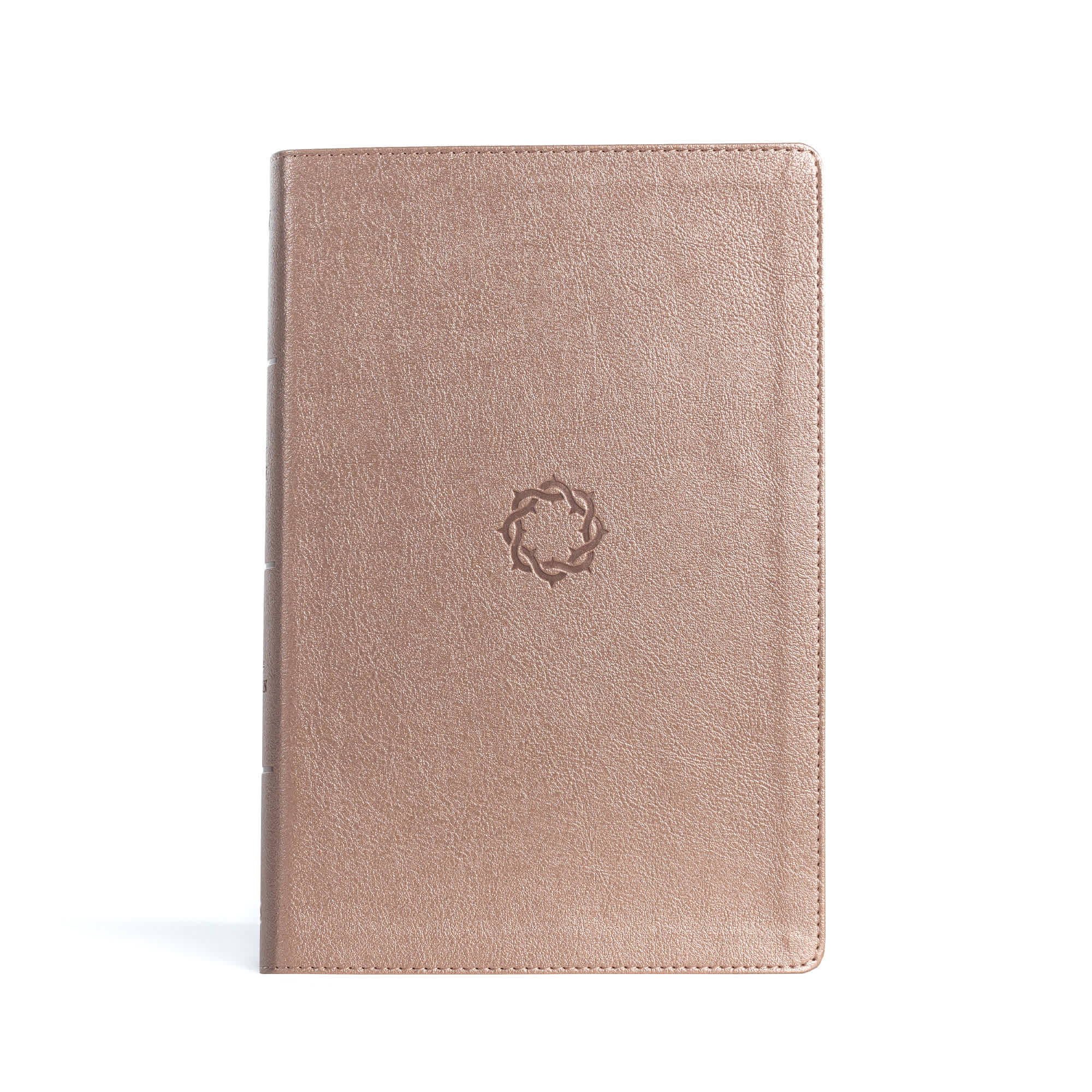 Bible with a rose gold cover and a crown of thorns embossed on the front.