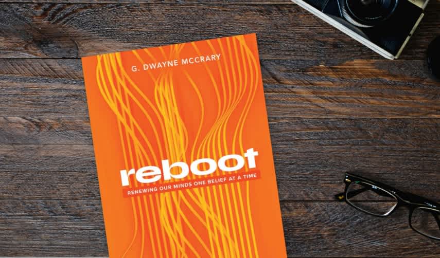 Reboot orange book on wooden table