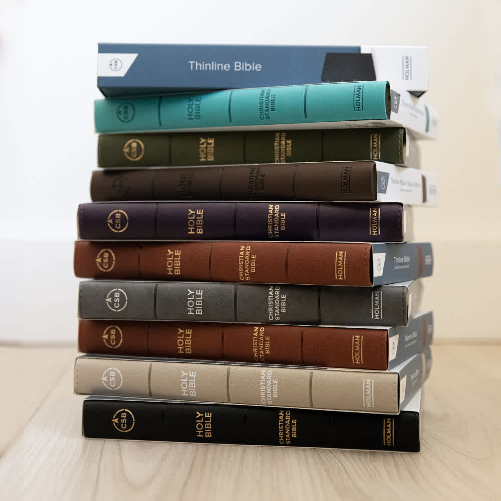 Thinline Bible on a table with a pen and cup of coffee.