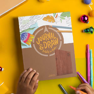 Journal & Draw Bible for Kids on top of wrapping paper