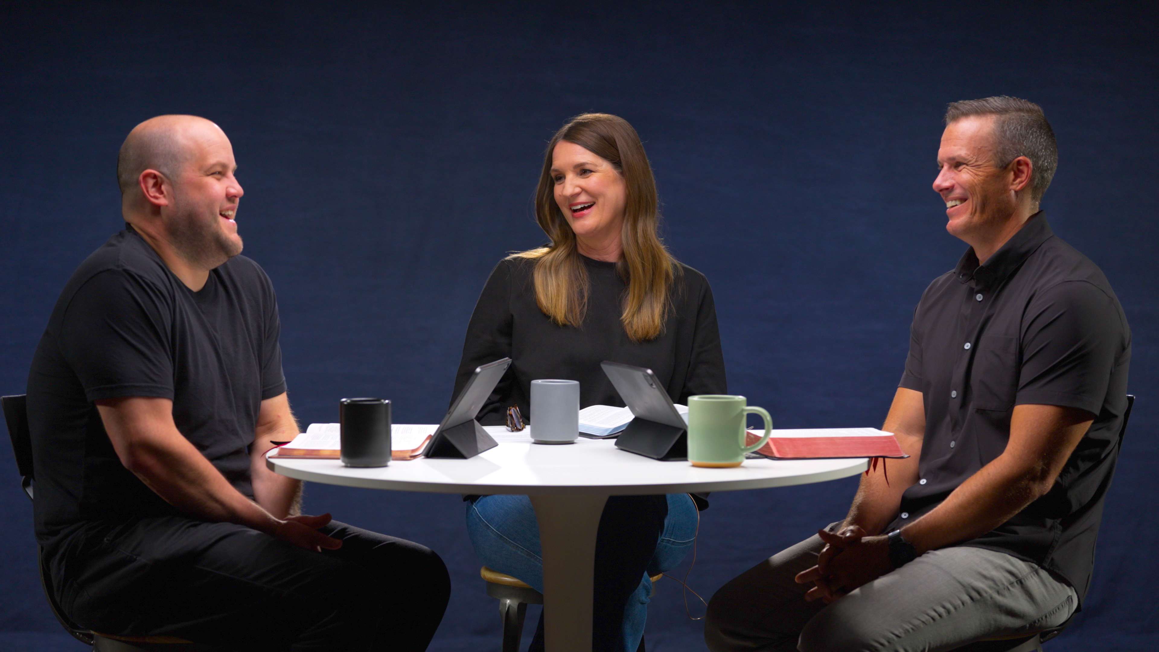 Kyle Worley, JT English, and Kelly Minter smiling around a white circular table