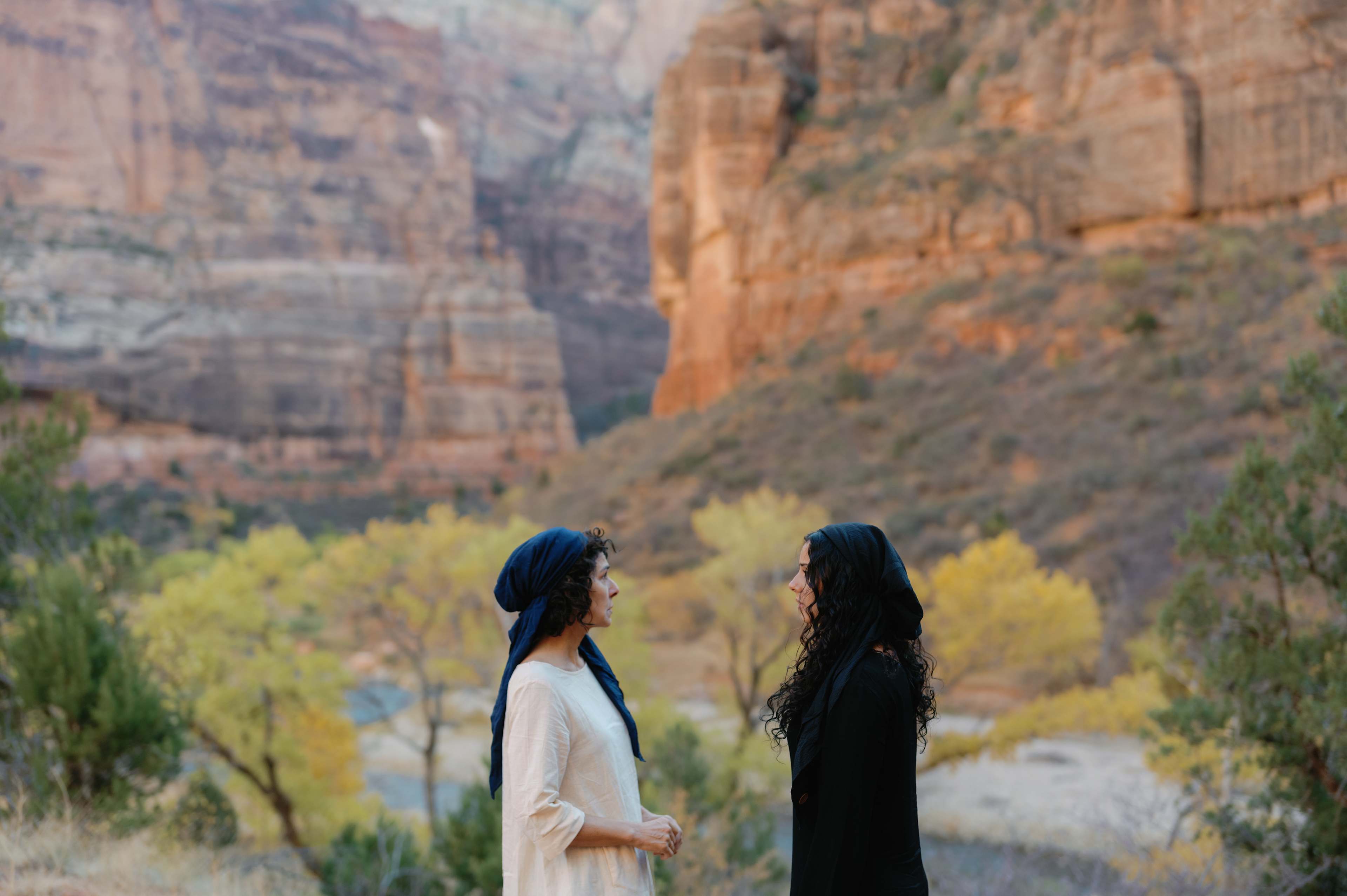 two women talking in the mountains