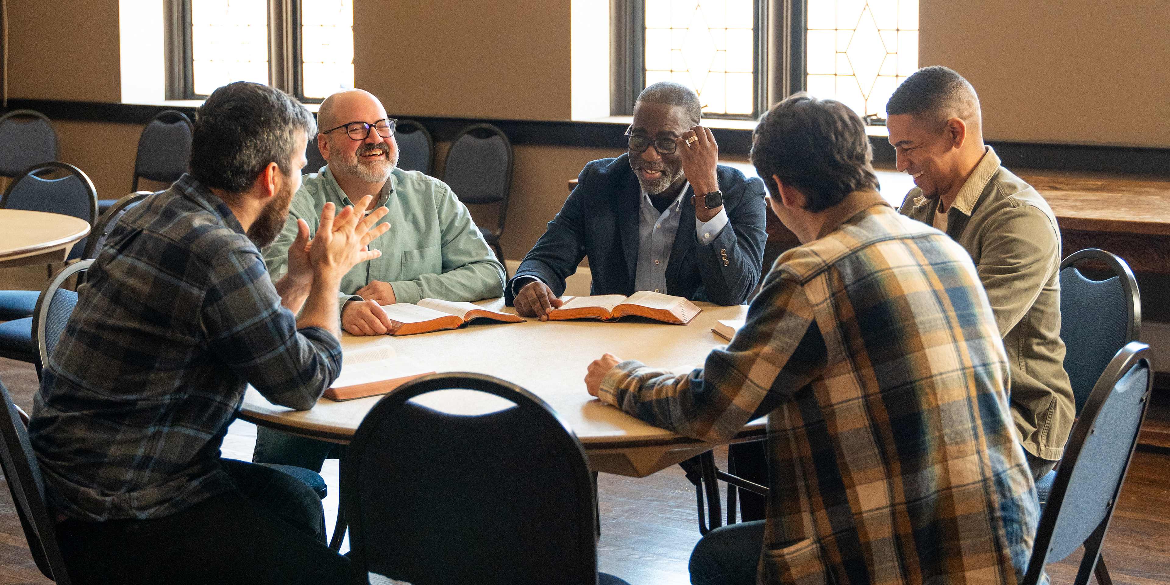 men studying the Bible at a round table