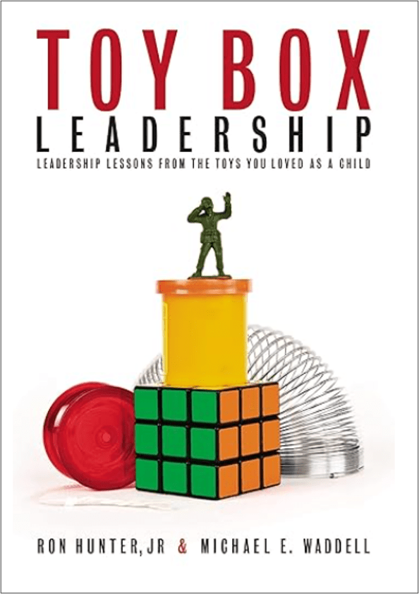 Toy Box Leadership book cover with yo-yo, slinky, rubix cube and playdough container.