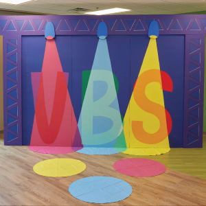 animated stage with three spotlights showing VBS letters