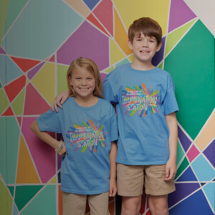 boy and girl in blue shirt with arms around shoulders