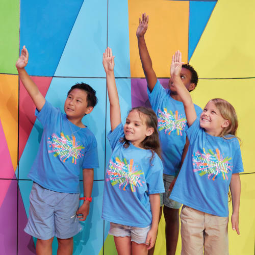 kids and woman reading VBS book