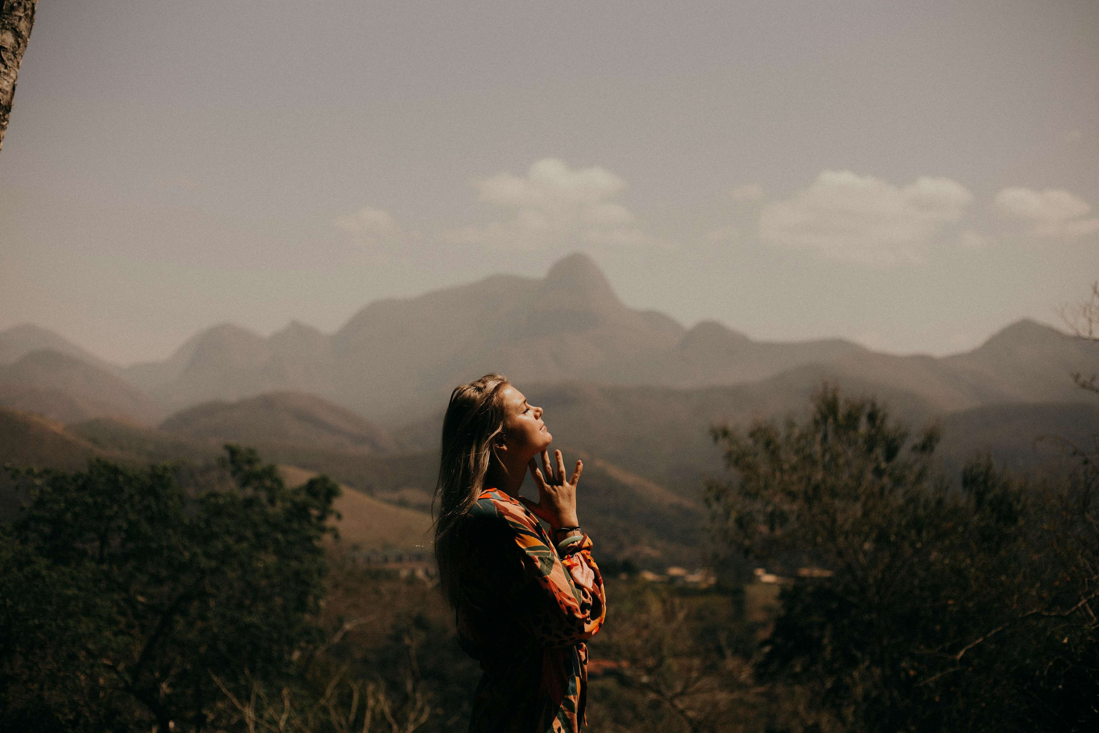 woman praying in the mountains