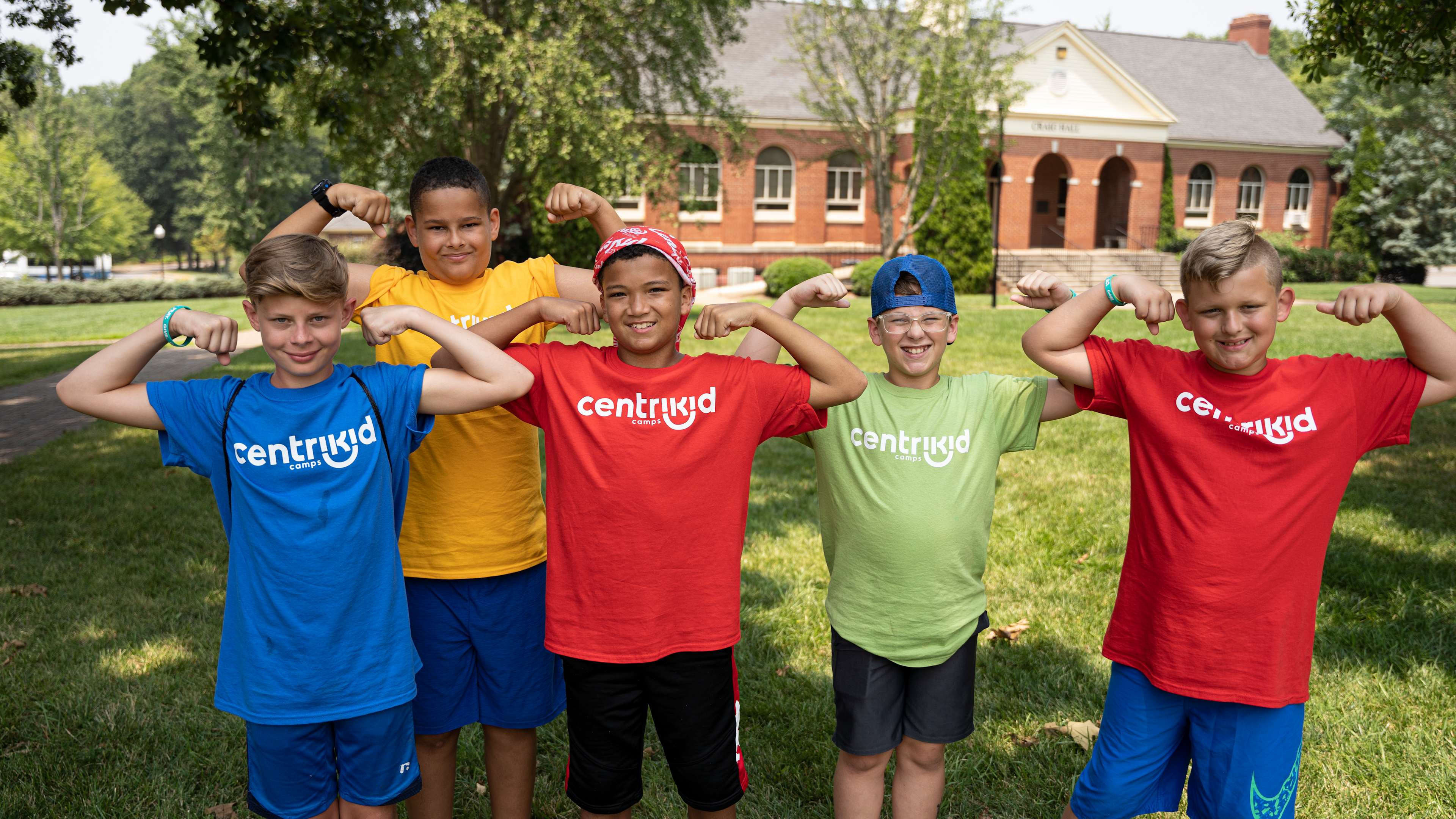 Five boys in CentriKid shirts flexing arms