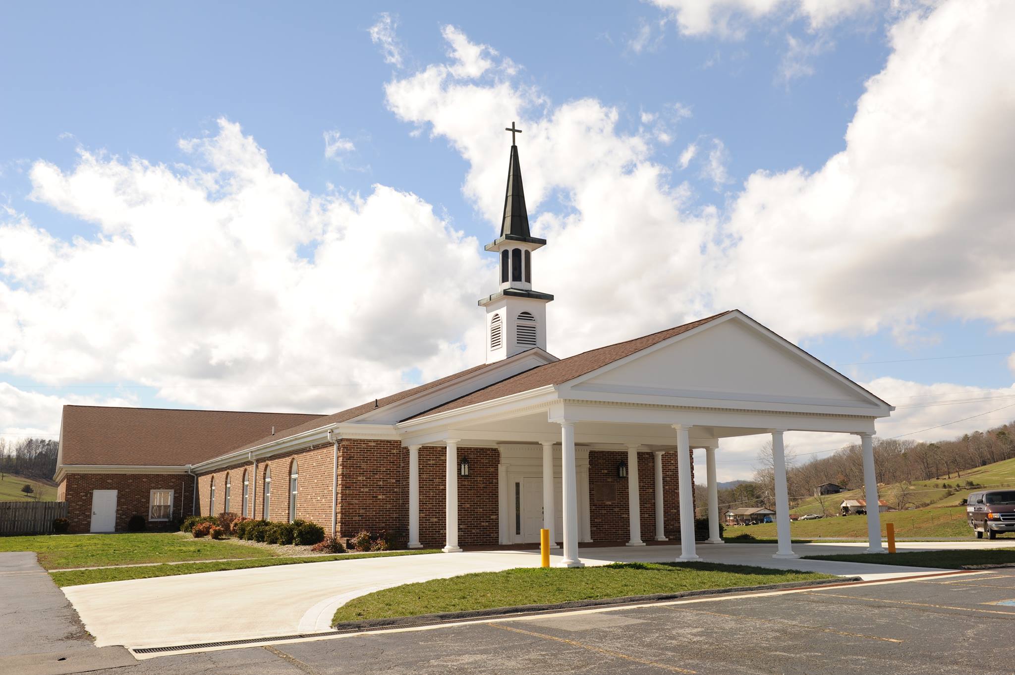 church with blue skies and clouds