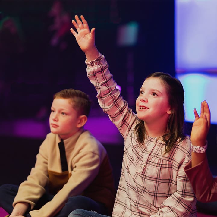 kids raising hands