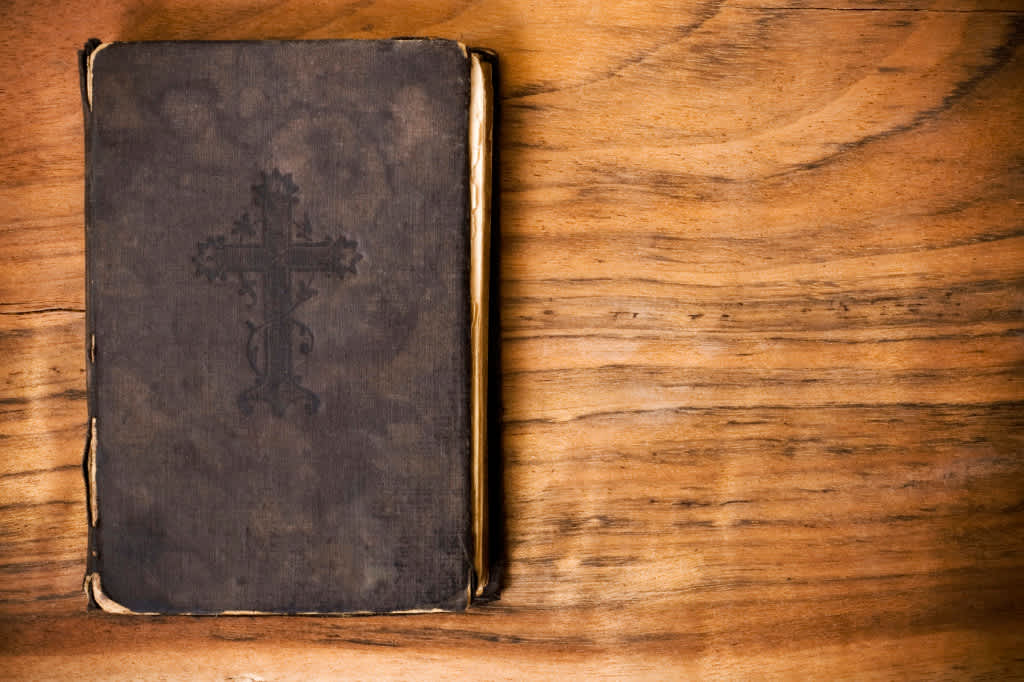 Image of a Bible on a wooden table.