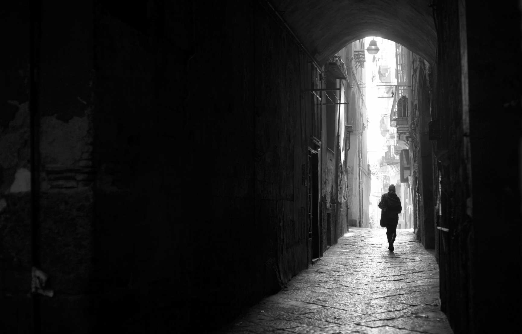 Person walking in dark alley way