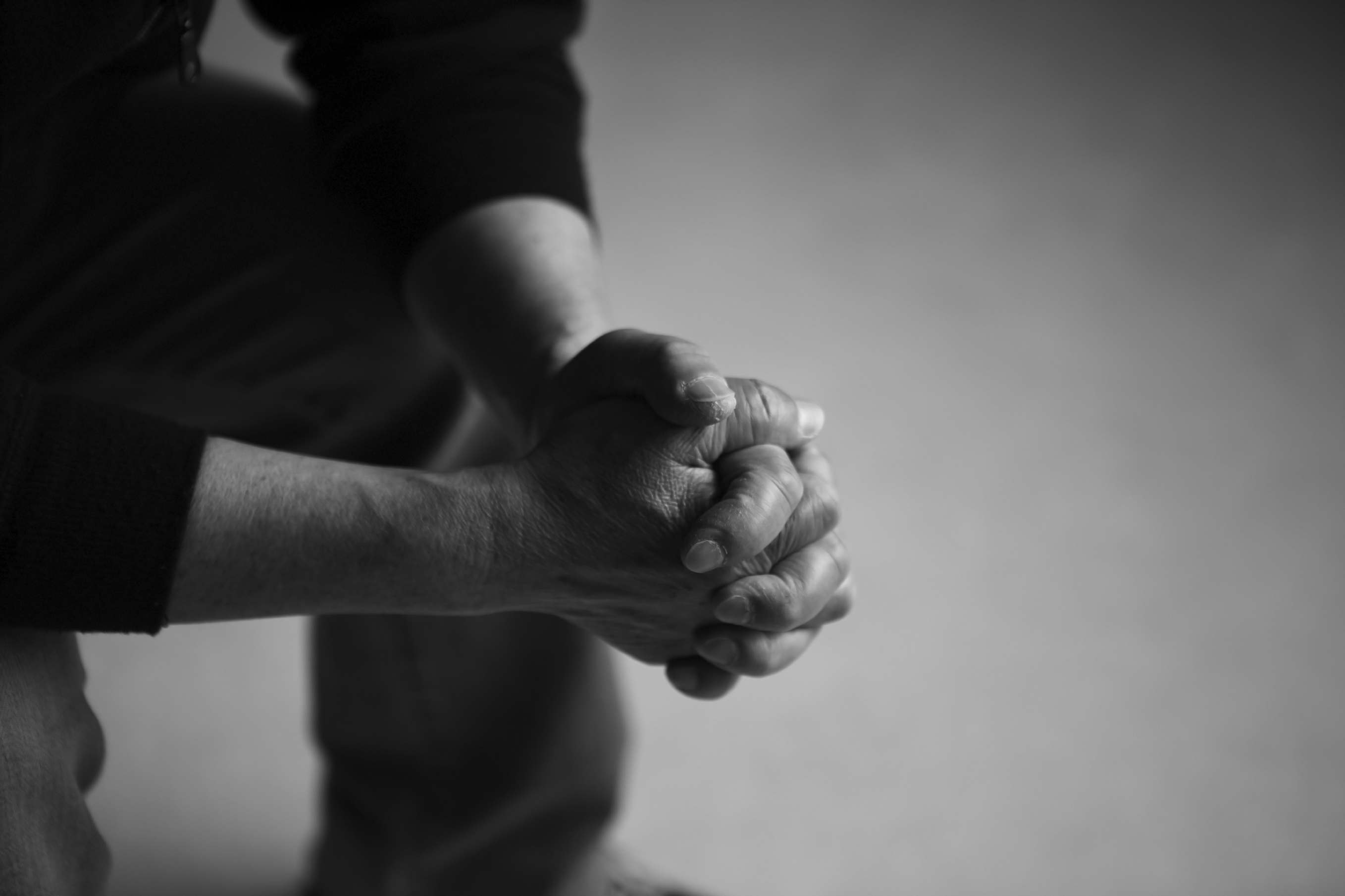 Man praying in black and white image