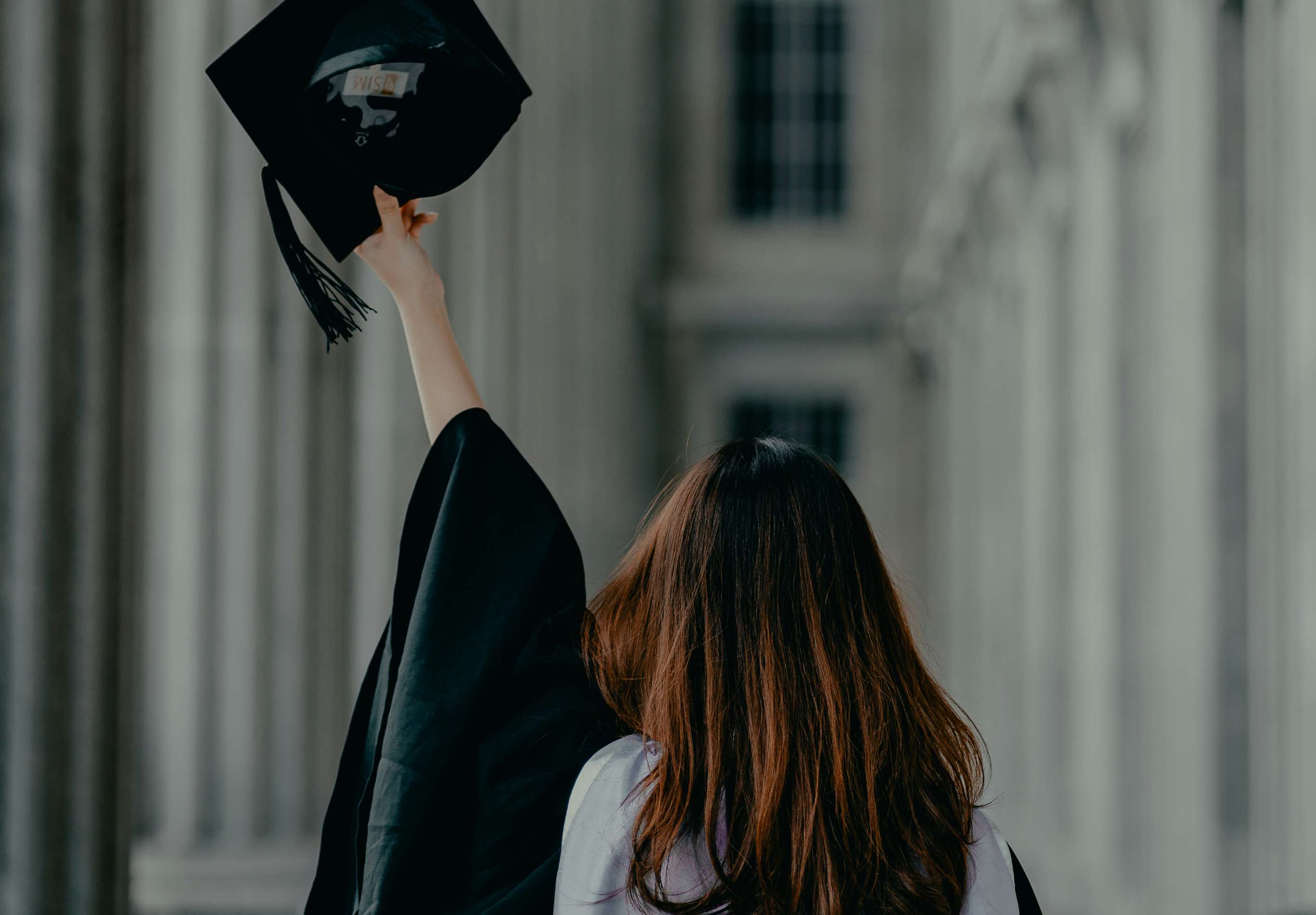 graduate holding graduation cap