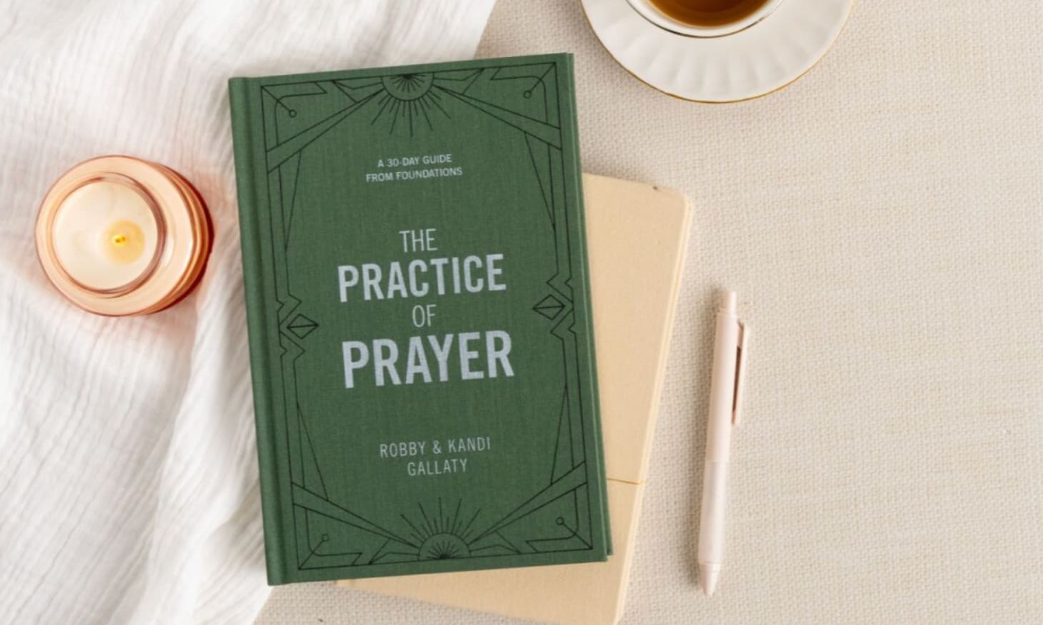 practice of prayer book with a candle and hot tea