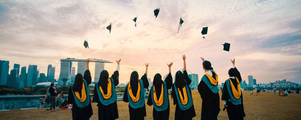Graduates throwing caps in the air