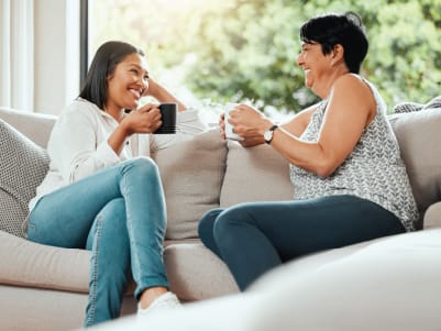 women on couch laughing