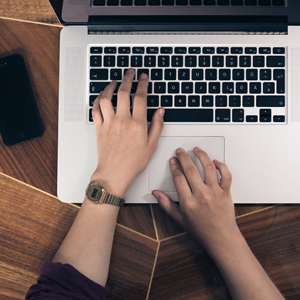 hands typing on computer