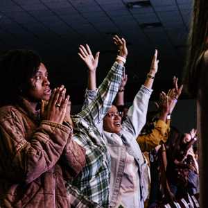 women standing and worshiping