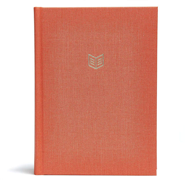 Orange hardcover book with a minimalist logo on the front.