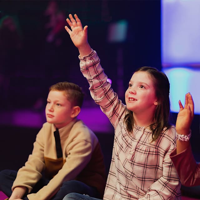 kids raising hands